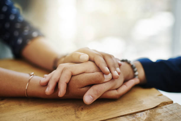 Two people holding hands